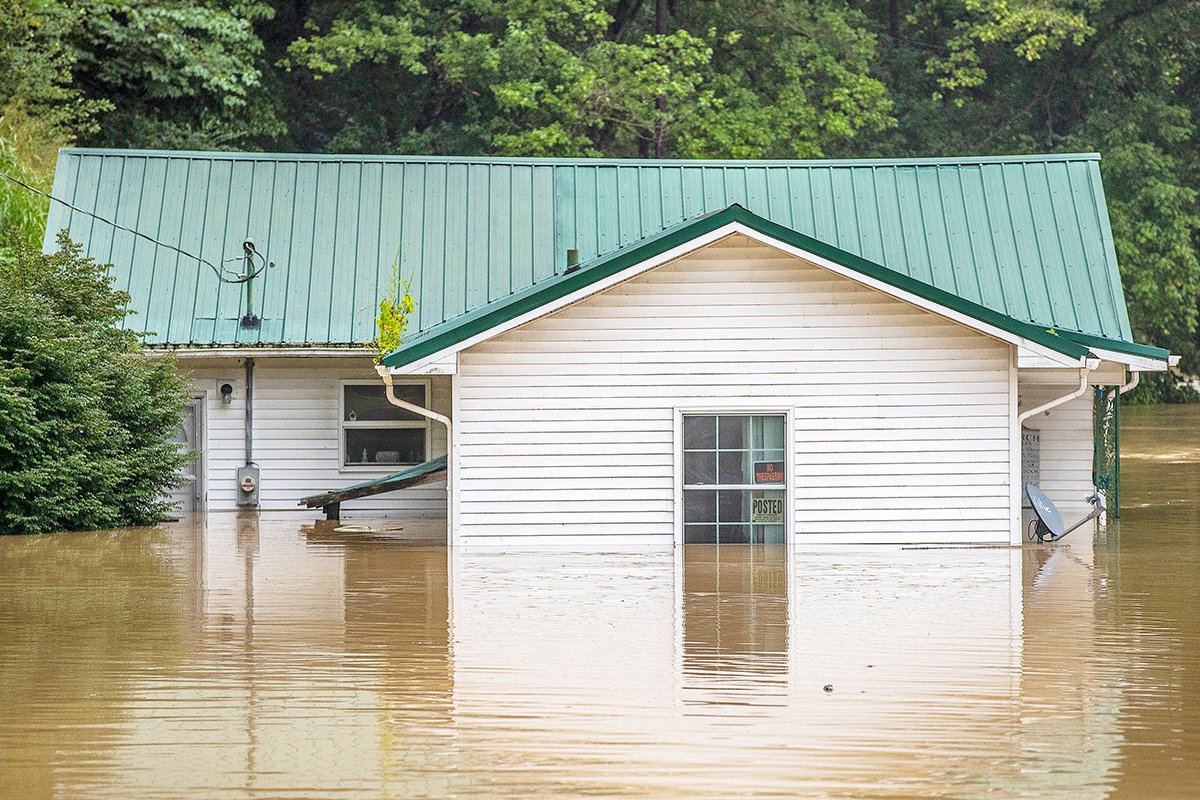 Homes are flooded by Lost Creek, Ky., on Thursday, July 28, 2022. Heavy rains have caused flash flooding and mudslides as storms pound parts of central Appalachia. Kentucky Gov. Andy Beshear says it’s some of the worst flooding in state history.